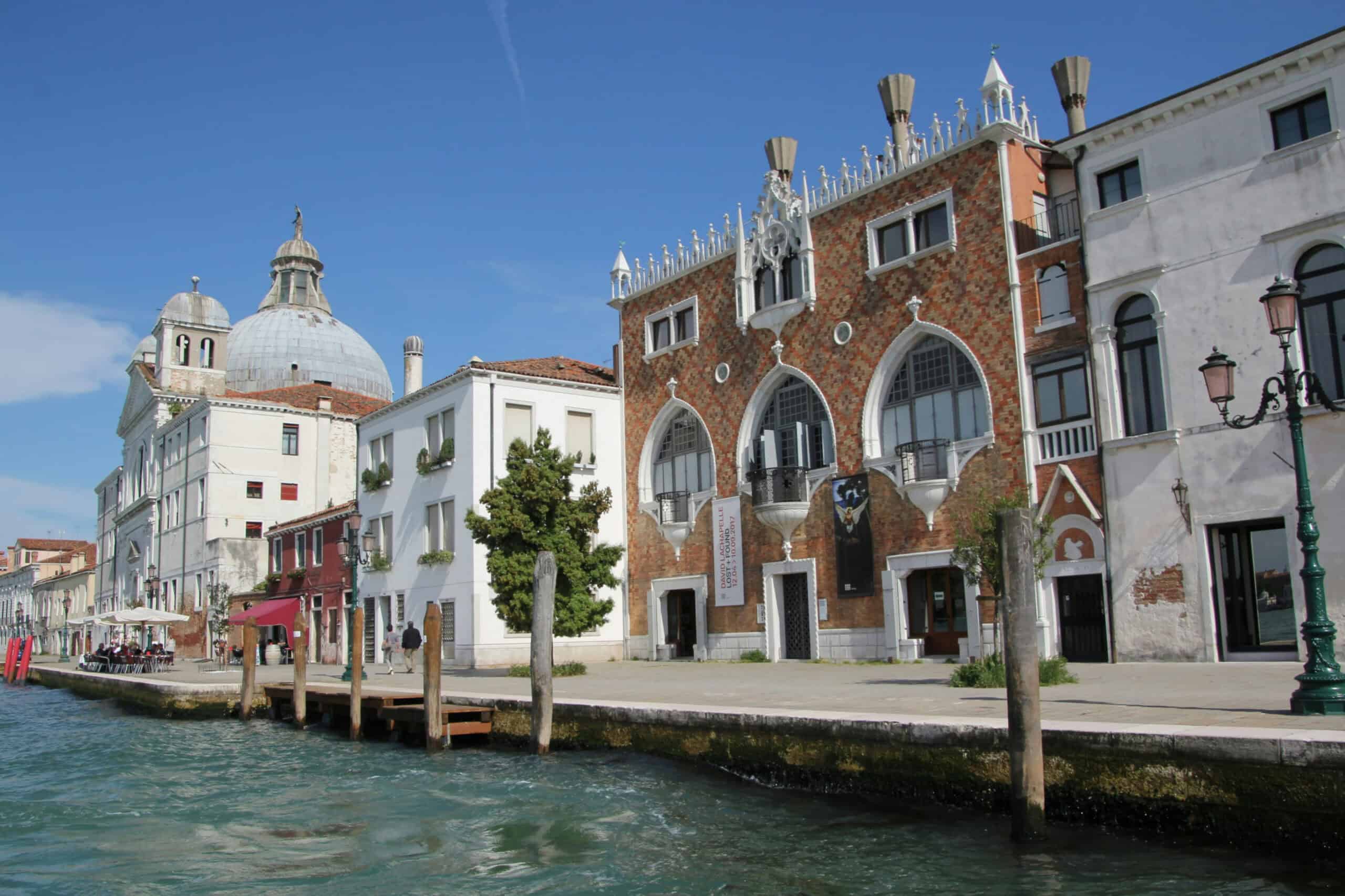 Charming Venetian buildings with unique designs line the canal in Venice, Italy.